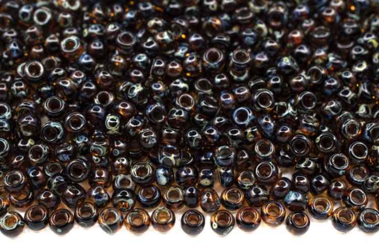 Бисер японский MIYUKI круглый 11/0 #4502 темный янтарь, прозрачный пикассо, 10 грамм Бисер японский MIYUKI круглый 11/0 #4502 темный янтарь, прозрачный пикассо, 10 грамм